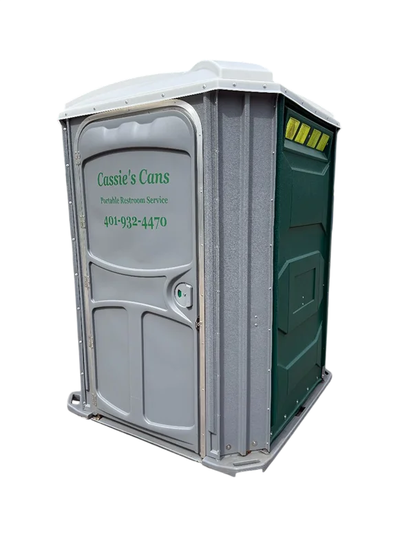 A wide, wheelchair-accessible portable restroom featuring a light gray front door and framing, dark green side panels, and a white roof. The front door displays the company name 'Cassie's Cans,' the text 'Portable Restroom Service,' and the phone number '401-932-4470' in green lettering. The unit sits flat on the ground to provide step-free entry.